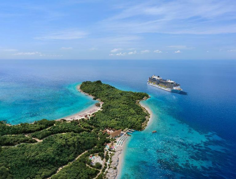 Aerial view of Royal Beach Club Lelepa island in Vanuatu with Royal Caribbean cruise ship anchored offshore
