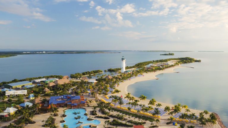 Aerial view of Harvest Caye Belize showing pool beach lighthouse and lagoon Norwegian Cruise Line private island