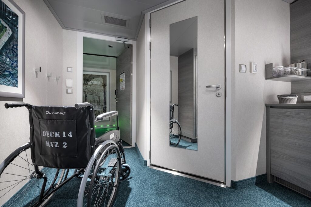 Wheelchair parked in an MSC Cruises accessible stateroom hallway with mirror reflection