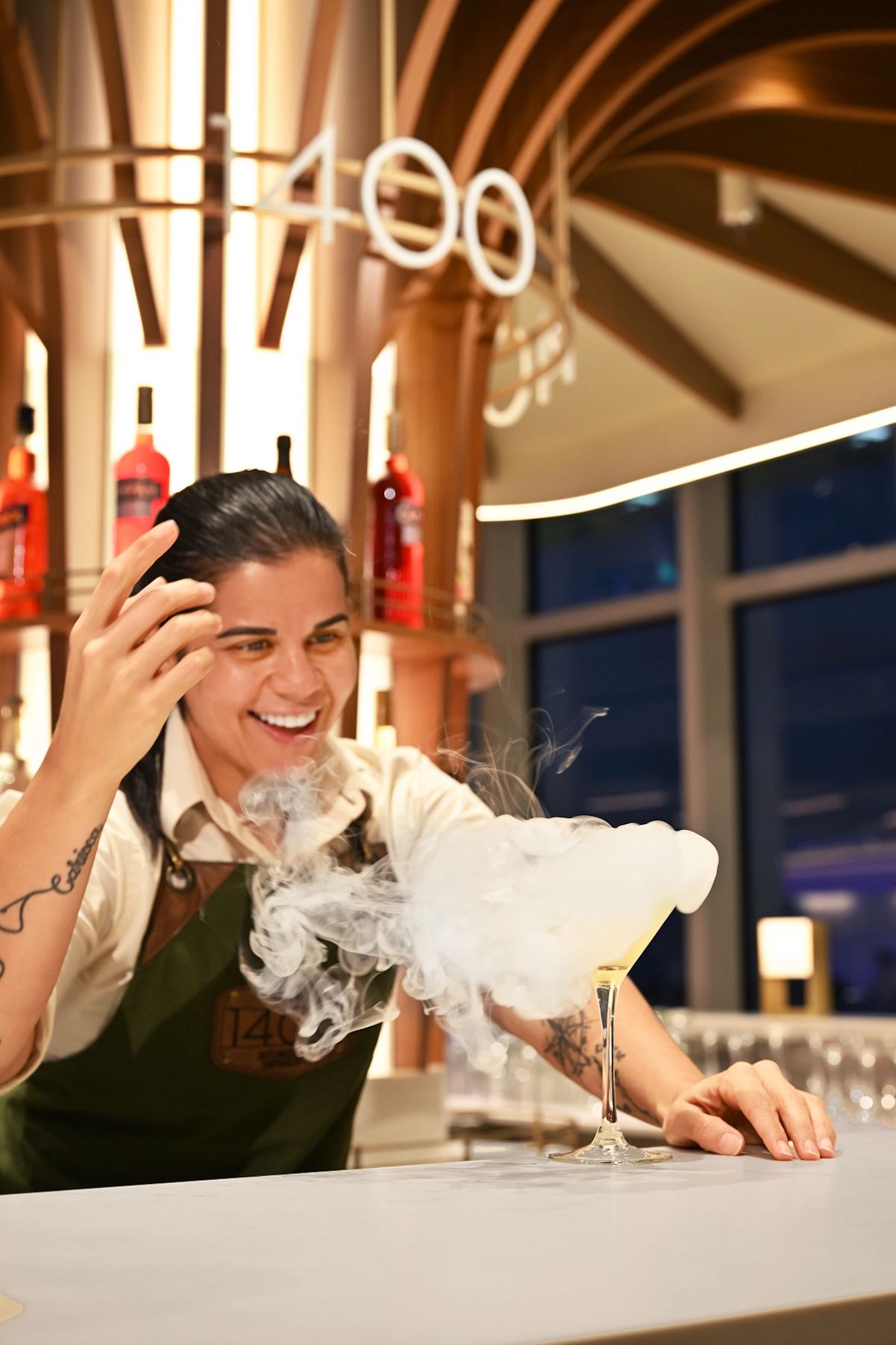 Bartender crafting a signature cocktail at 1400 Lobby Bar, one of the most popular Icon of the Seas bars
