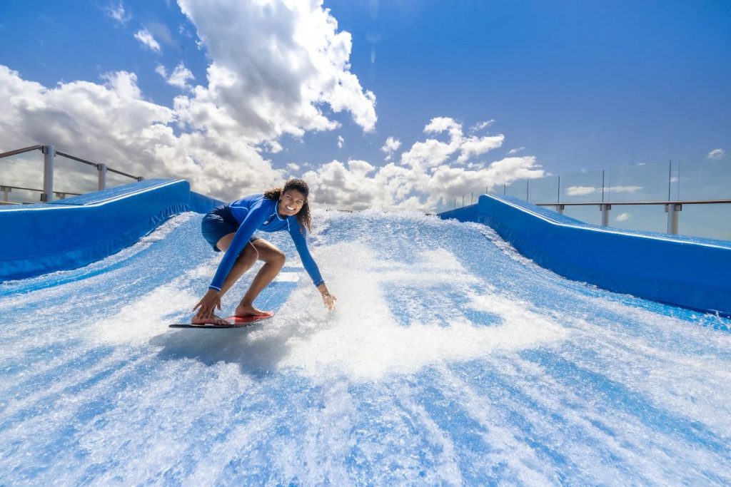 UPF rash guard in action on a cruise ship FlowRider — real cruise sun protection at work