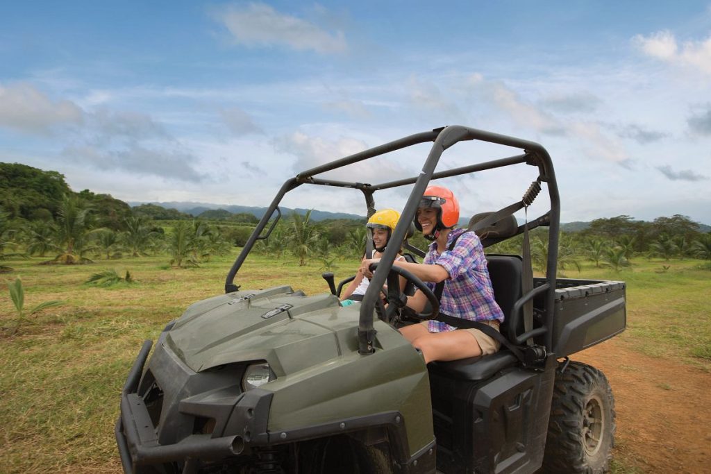 Royal Caribbean shore excursion guests wearing required safety helmets on an ATV tour in Falmouth, Jamaica