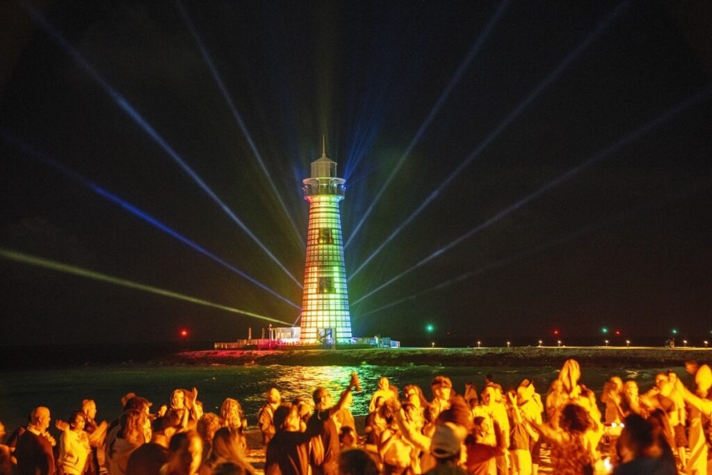 Guests watching the LED lighthouse show during the Luna Libre beach party