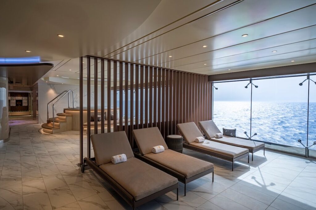 Quiet cruise ship spa lounge with ocean view through floor-to-ceiling windows