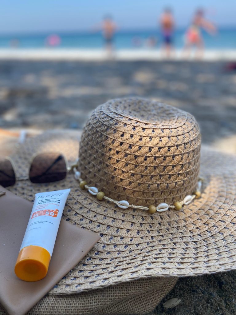 Sun hat, sunscreen, and sunglasses — essential cruise sun protection gear