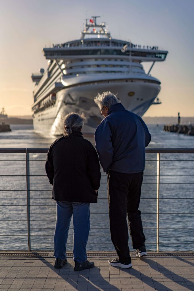 Passengers watching their ship arrive, staying aware and informed