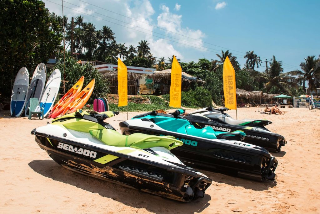 Jet skis for rent on a beach near a cruise port — a common source of rental scams targeting tourists