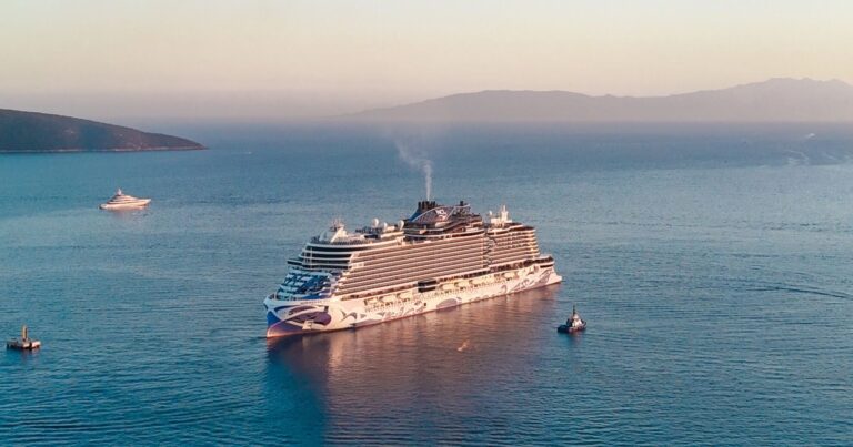 Cruise ship sailing calmly into a quiet harbor at sunset, a reassuring image for anyone with a fear of cruising
