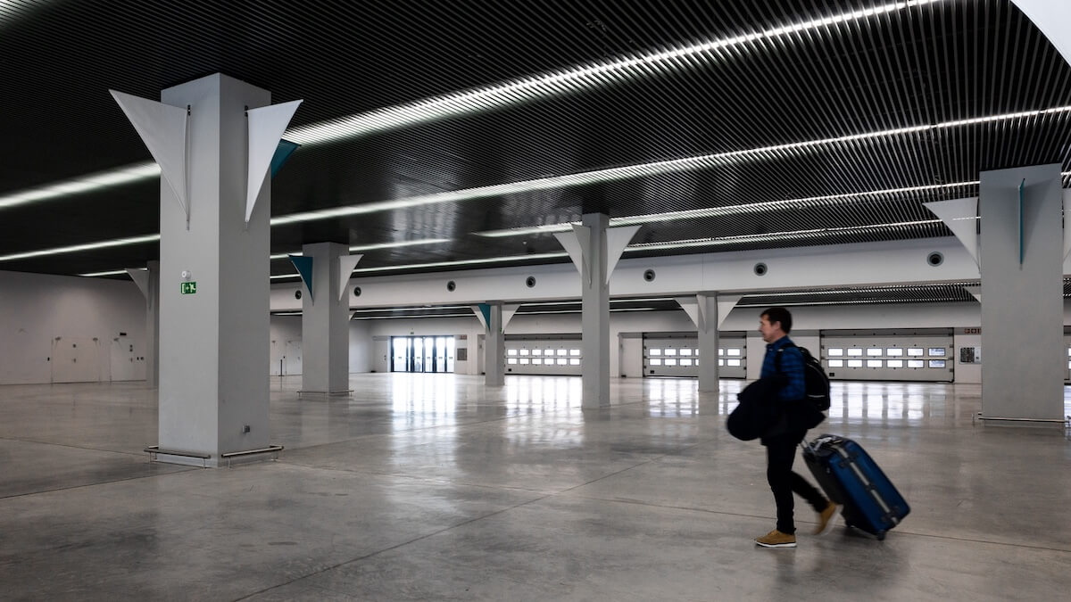Traveler walking through a modern terminal hall, documents needed for a cruise