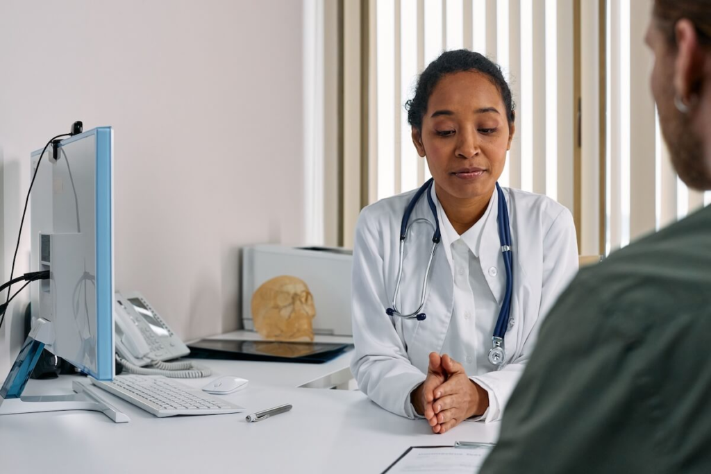 Doctor speaking with patient during a pre-cruise medical consultation