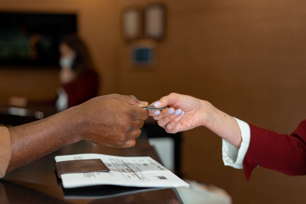 Traveler checking in and handing over documents at a counter