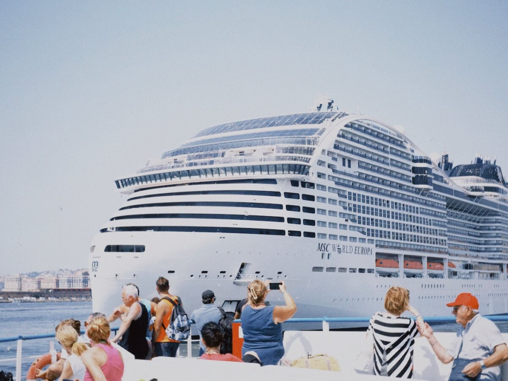 Tourists watching a cruise ship at sea on embarkation day