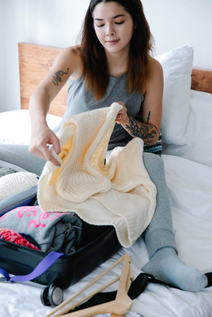 Traveler packing a suitcase during final preparation week