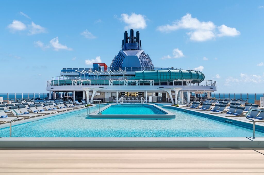 Spacious, uncrowded cruise ship pool deck with rows of empty loungers
